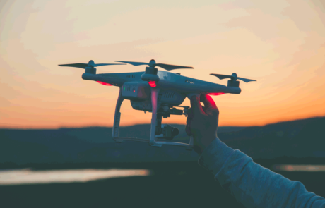drone in hand in front of a sunset